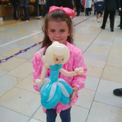 Child holding Princess Elsa balloon at an event in London