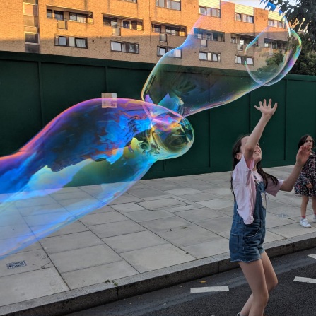 Giant rainbow bubbles in the street