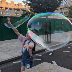 Giant rainbow bubbles in the street