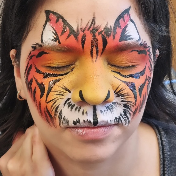 Tiger face paint on adult woman