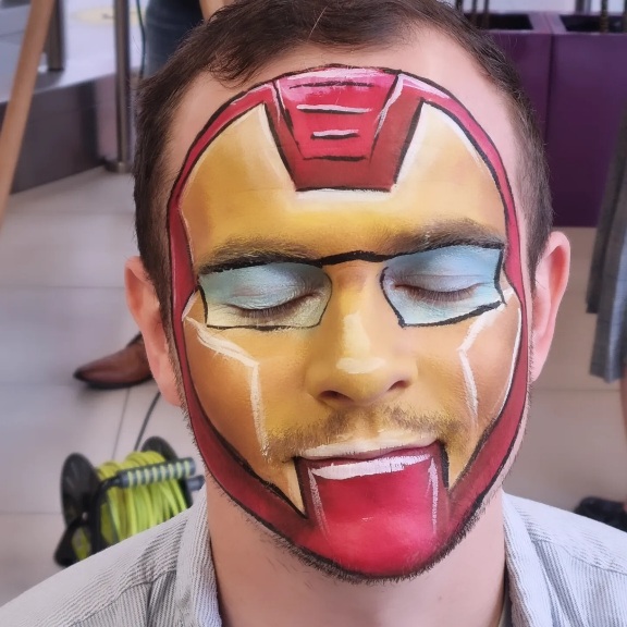 Face painting on an adult, Iron Man design