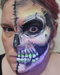 Half face skull face paint design with high detail
