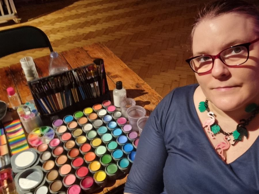 Professional face painting setup with safe paints and clean brushes