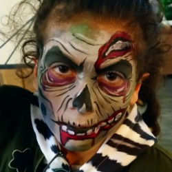 Girl face painted as a zombie at a Halloween event