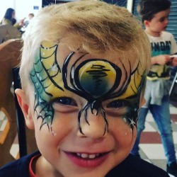 Boy with spider face paint for halloween