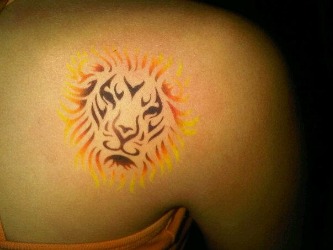 Airbrush temporary tattoo of a lion in black, yellow and gold