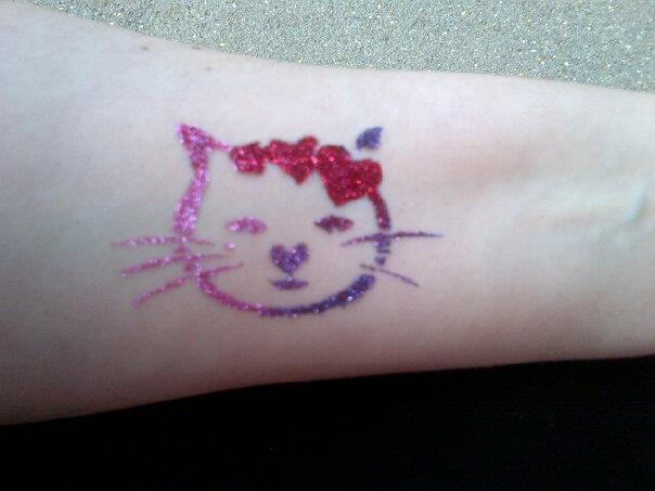 Girls glitter tattoo designs at a children's party Girls glitter tattoo designs at a children's party