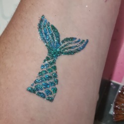 Mermaid's tail glitter tattoo from a themed party